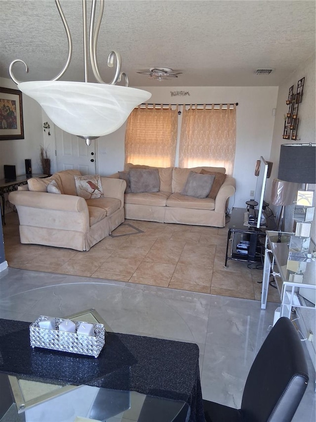 3380 Maple Ter, Port Charlotte, FL 33952 - tiled living room with a textured ceiling and visible vents