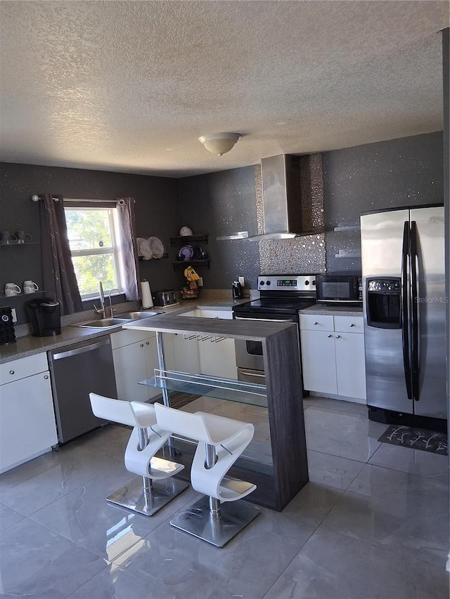 3380 Maple Ter, Port Charlotte, FL 33952 - kitchen with wall chimney exhaust hood, a textured ceiling, stainless steel appliances, white cabinets, and decorative backsplash