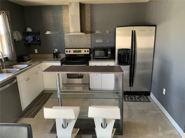 3380 Maple Ter, Port Charlotte, FL 33952 - kitchen featuring stainless steel appliances, white cabinetry, a sink, wall chimney range hood, and tile patterned flooring