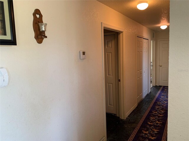 3380 Maple Ter, Port Charlotte, FL 33952 - hallway featuring a textured wall and a textured ceiling