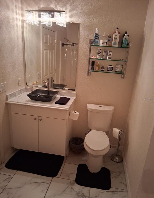 3380 Maple Ter, Port Charlotte, FL 33952 - bathroom featuring a shower with shower curtain, toilet, vanity, marble finish floor, and baseboards