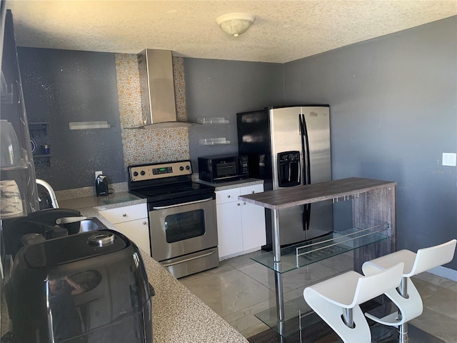 3380 Maple Ter, Port Charlotte, FL 33952 - kitchen with a textured ceiling, appliances with stainless steel finishes, white cabinetry, a sink, and wall chimney range hood