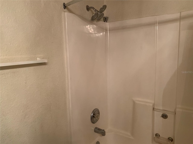 3380 Maple Ter, Port Charlotte, FL 33952 - details featuring a textured wall and shower / washtub combination