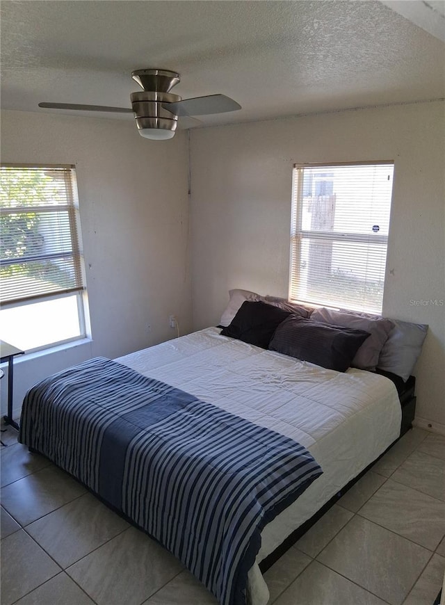 3380 Maple Ter, Port Charlotte, FL 33952 - bedroom featuring tile patterned floors, ceiling fan, and a textured ceiling