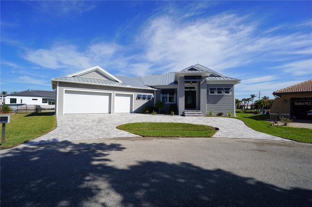 view of front facade featuring a garage and a front lawn