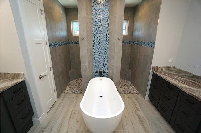 bathroom with vanity, plus walk in shower, and wood-type flooring