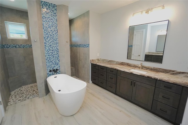 bathroom with vanity and separate shower and tub