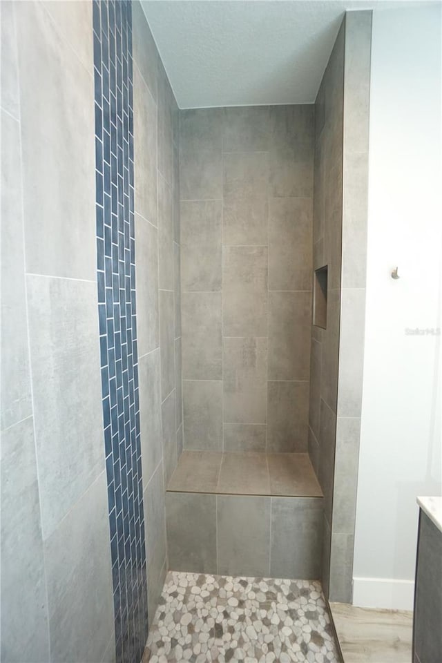 bathroom with tiled shower