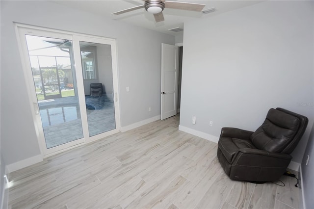 living area featuring ceiling fan and light wood-type flooring