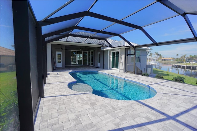 view of pool with a water view, a patio area, and a lanai