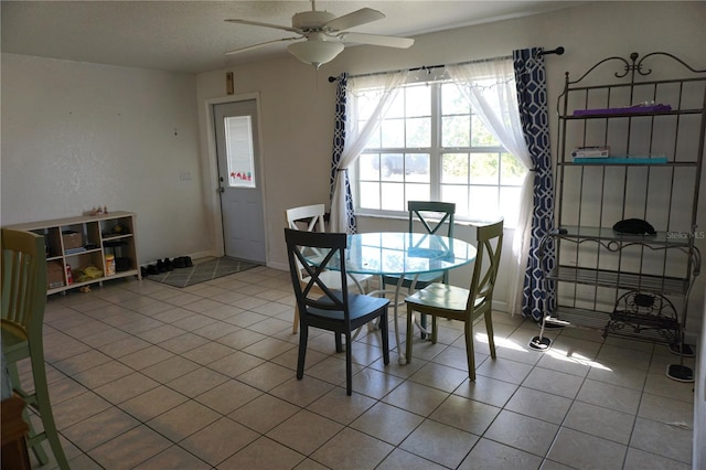 tiled dining area with ceiling fan