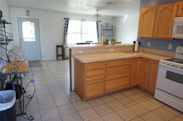 kitchen featuring white appliances, kitchen peninsula, ceiling fan, and light tile patterned flooring