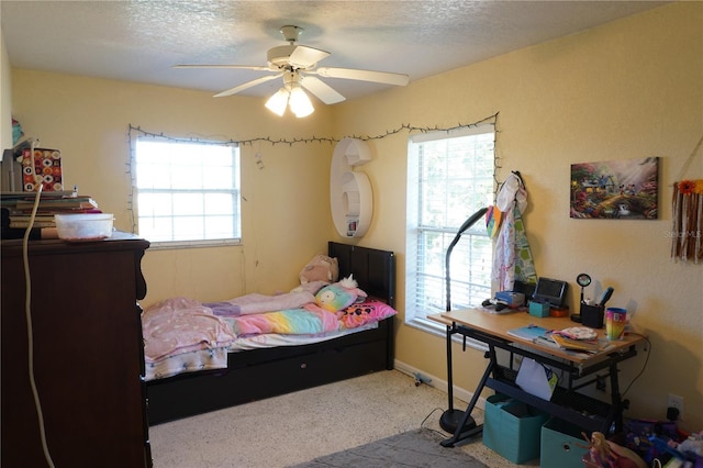 bedroom featuring ceiling fan and a textured ceiling