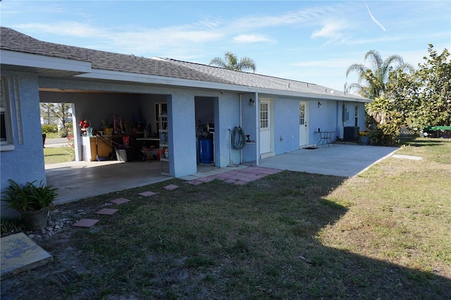 back of property with cooling unit, a yard, and a patio