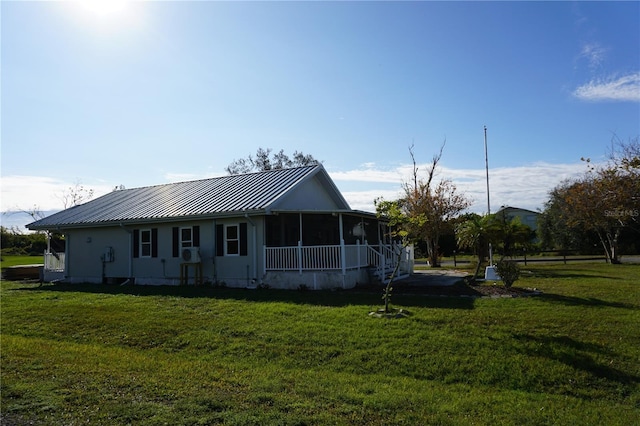 rear view of house with a yard