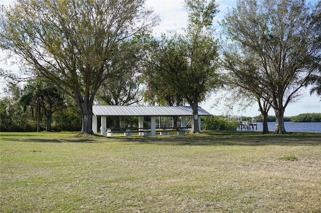 view of community featuring a gazebo, a lawn, and a water view