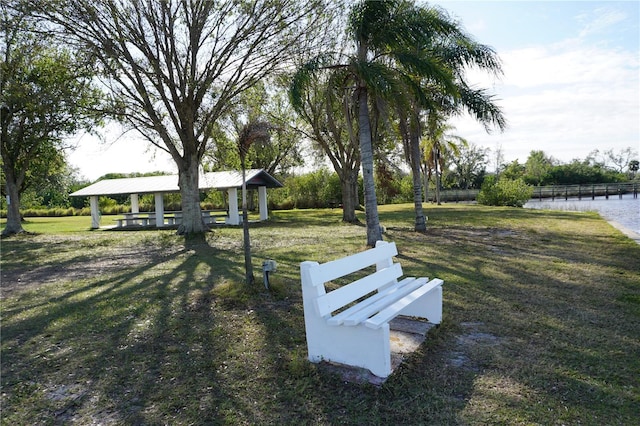 view of home's community with a gazebo, a water view, and a yard