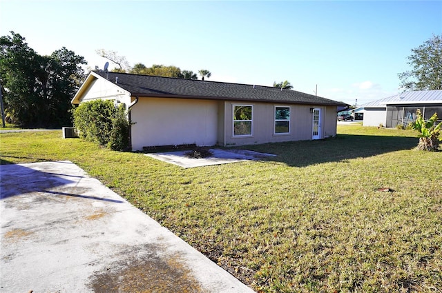 back of house featuring a lawn and a patio