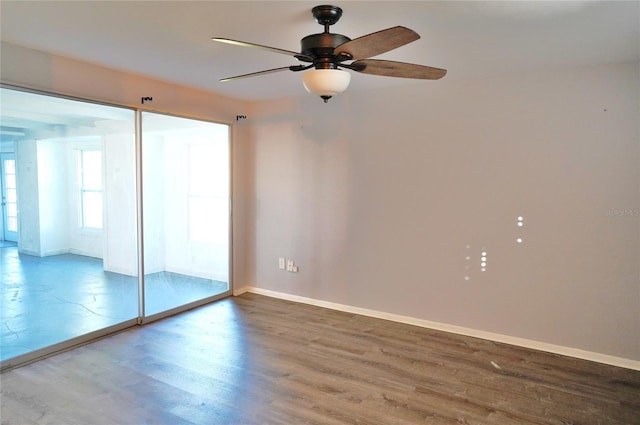 spare room with hardwood / wood-style floors and ceiling fan