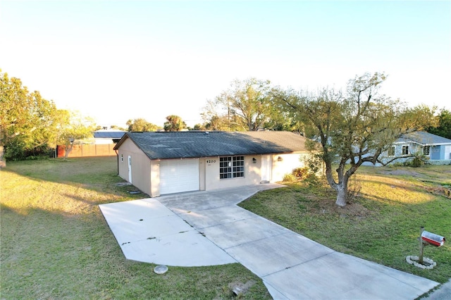 ranch-style home with a garage and a front lawn