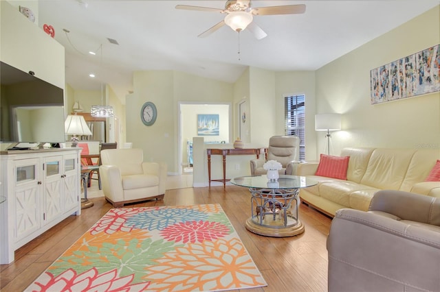 living room featuring ceiling fan, lofted ceiling, and light hardwood / wood-style floors