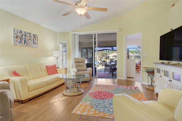 living room featuring lofted ceiling, light hardwood / wood-style floors, and ceiling fan