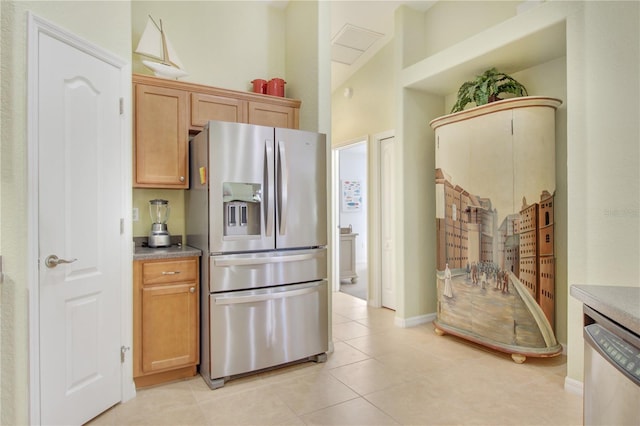 kitchen with light tile patterned flooring and stainless steel appliances