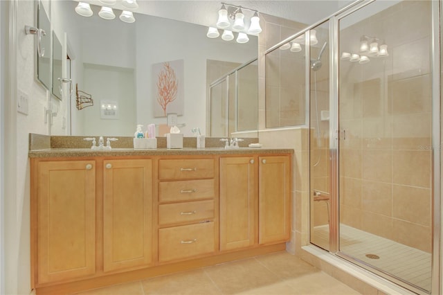 bathroom with tile patterned floors, an enclosed shower, and vanity