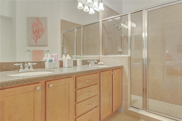 bathroom featuring vanity, tile patterned floors, and a shower with door