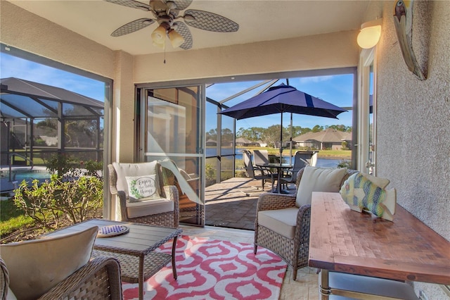 sunroom with a healthy amount of sunlight and ceiling fan