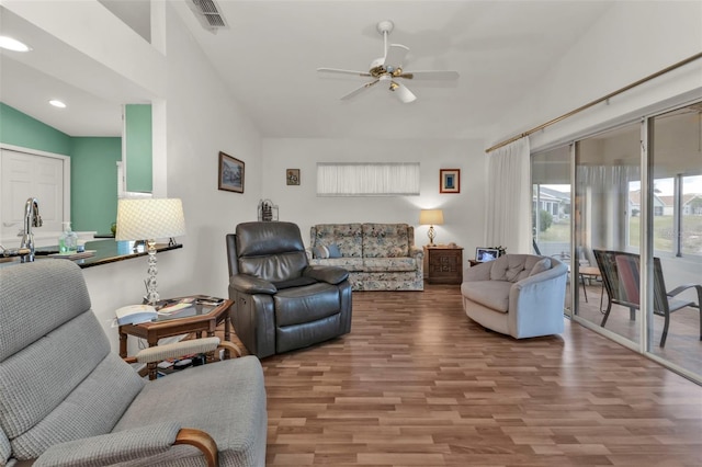 living room with wood-type flooring and ceiling fan