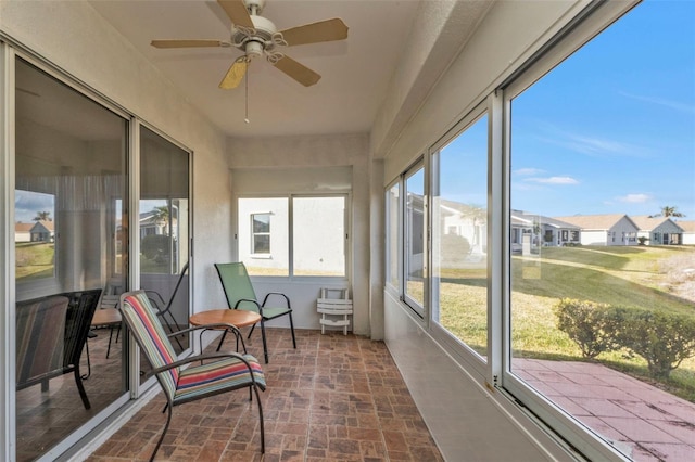 sunroom / solarium featuring ceiling fan