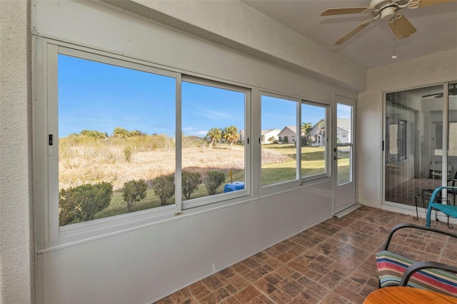 sunroom / solarium with ceiling fan