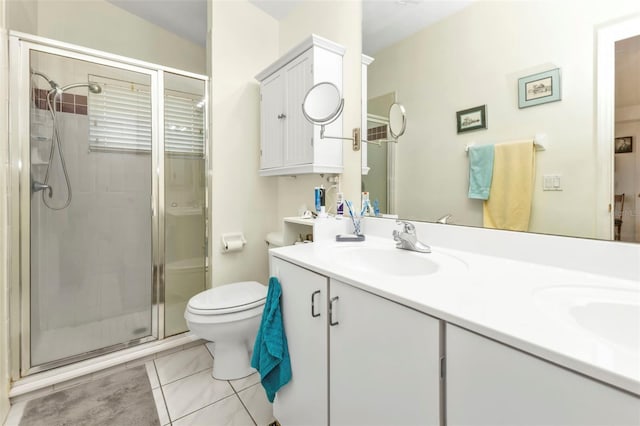 bathroom featuring vanity, a shower with shower door, and toilet