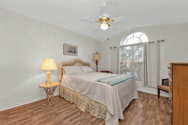 bedroom featuring lofted ceiling, ceiling fan, and light wood-type flooring