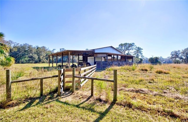 exterior space featuring a rural view and an outbuilding