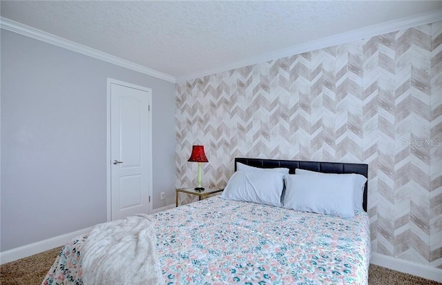 carpeted bedroom with ornamental molding and a textured ceiling