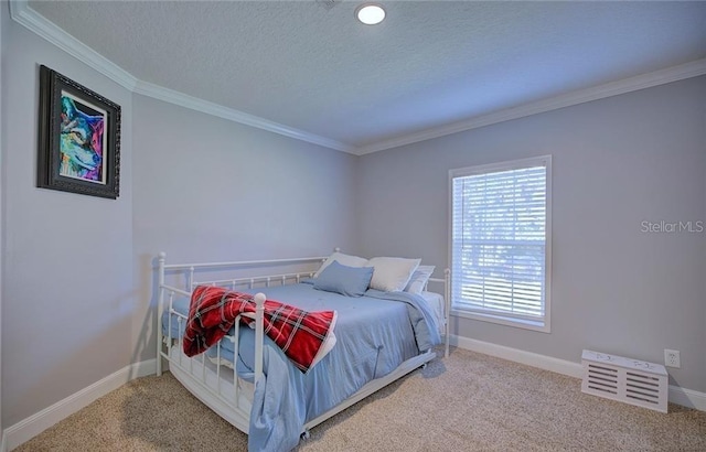 carpeted bedroom featuring ornamental molding and a textured ceiling