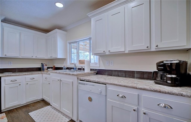 kitchen featuring ornamental molding, dark hardwood / wood-style floors, dishwasher, light stone countertops, and white cabinets