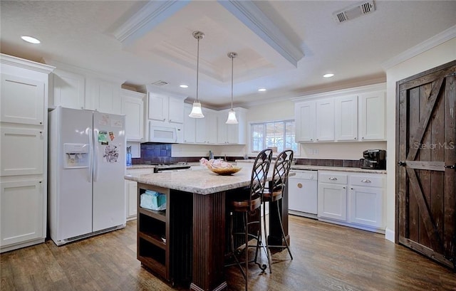 kitchen featuring white cabinetry, white appliances, hanging light fixtures, and a kitchen island