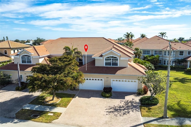 view of front of house with a garage and a front yard