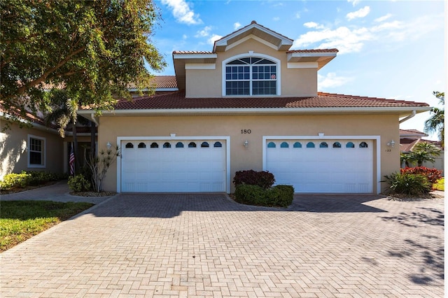 mediterranean / spanish house with a garage