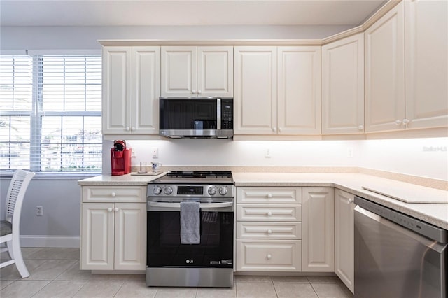 kitchen with appliances with stainless steel finishes and light tile patterned floors