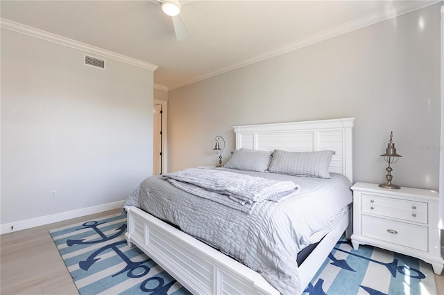 bedroom featuring ornamental molding, ceiling fan, and light wood-type flooring