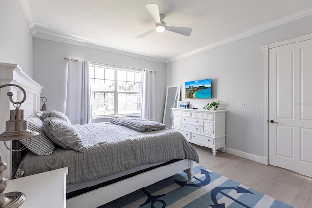 bedroom with crown molding, light hardwood / wood-style flooring, and ceiling fan