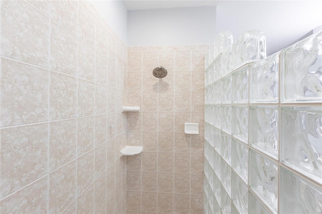 bathroom with a tile shower