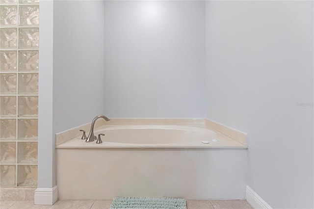 bathroom featuring tile patterned floors and a tub to relax in