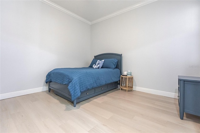 bedroom with hardwood / wood-style flooring and ornamental molding