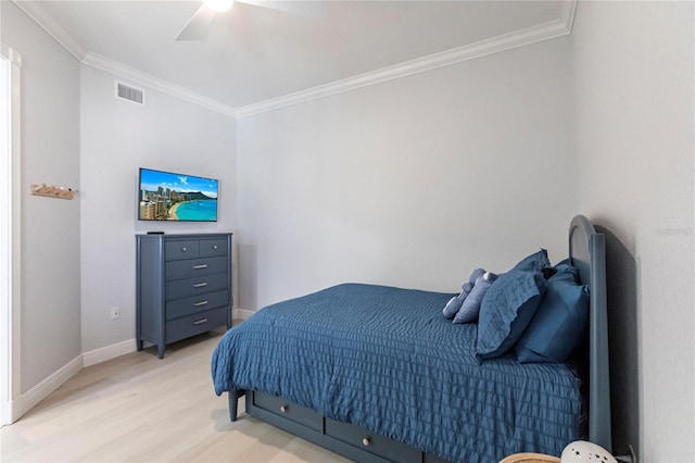 bedroom featuring ornamental molding, ceiling fan, and light wood-type flooring