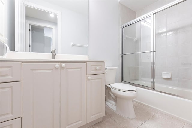 full bathroom with toilet, vanity, shower / bath combination with glass door, and tile patterned flooring